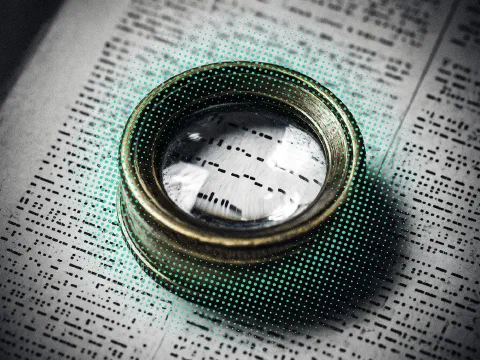 A brass loupe resting on a printed page, with teal halftone dots spreading from the lens
