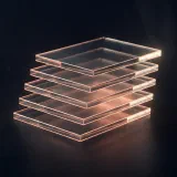 Five offset glass slabs stacked like layered pull requests, edged in peach light